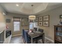 Cozy dining room featuring a modern light fixture, a fireplace, and tasteful decor at 10557 E Fanfol Ln, Scottsdale, AZ 85258