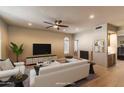 Bright and airy living room with high ceilings, a fireplace, and modern furnishings at 10557 E Fanfol Ln, Scottsdale, AZ 85258