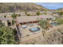 Aerial view of the fenced backyard featuring a covered patio, hot tub, and pool with desert mountain views at 10672 N 140Th Way, Scottsdale, AZ 85259