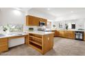 Modern kitchen features natural wood cabinets, white countertops, stainless steel appliances, and a wine fridge at 11686 N Spotted Horse Way, Fountain Hills, AZ 85268