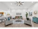 Bright living room with tile floors, modern fan, stylish furniture and a large window overlooking the backyard at 11686 N Spotted Horse Way, Fountain Hills, AZ 85268