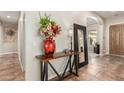 Stylish entryway featuring a decorative table with flowers and a large mirror at 12320 W Lone Tree Trl, Peoria, AZ 85383