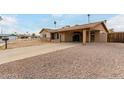 Single-story house with a covered driveway and low-maintenance desert landscaping at 12402 N 36Th Dr, Phoenix, AZ 85029