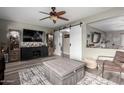 Bright living room features modern decor, a ceiling fan, and ample seating at 12402 N 36Th Dr, Phoenix, AZ 85029