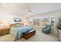 Inviting bedroom features a large window with shutters, a comfortable sitting chair, and stylish furniture at 14710 W Yosemite Dr, Sun City West, AZ 85375