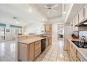 Spacious kitchen featuring a breakfast bar, tiled floors, and ample cabinet space at 14710 W Yosemite Dr, Sun City West, AZ 85375