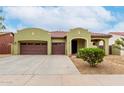 Charming home featuring a three-car garage, desert landscaping, and a welcoming entrance at 15620 W Meadowbrook W Ave, Goodyear, AZ 85395