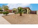 Charming home featuring a three-car garage, desert landscaping, and a welcoming entrance at 15620 W Meadowbrook W Ave, Goodyear, AZ 85395