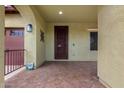 Inviting front porch with tiled floor, decorative door, and ample space for seating at 15620 W Meadowbrook W Ave, Goodyear, AZ 85395