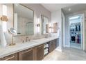 Bathroom featuring double sinks, marble countertops, and access to the walk-in closet at 16203 E Ridgeline Dr, Fountain Hills, AZ 85268