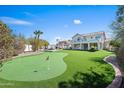 Expansive backyard with artificial turf, putting green, and a covered patio perfect for entertaining at 16646 S 16Th St, Phoenix, AZ 85048