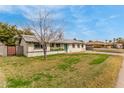 Charming single-story home showcasing a well-maintained front yard and white brick exterior at 1824 W State Ave, Phoenix, AZ 85021