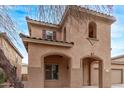 Lovely view of the home showing the covered entryway, windows, and a partial view of the driveway and landscaping at 18537 W Mariposa Dr, Surprise, AZ 85374