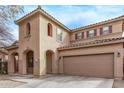 A front view of the home shows the covered entryway, driveway, and a two car garage at 18537 W Mariposa Dr, Surprise, AZ 85374