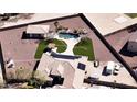 Stunning aerial view of the property highlighting a backyard pool, luscious turf, and a spacious perimeter at 18927 W Mitchell Ct, Litchfield Park, AZ 85340