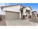 Charming single-story home boasts a two-car garage and stone pillar accents at 20318 W Turney Ave, Buckeye, AZ 85396