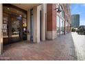 Attractive building entrance with a decorative glass door, brick columns, and a well-maintained brick pathway at 21 E 6Th St # 412, Tempe, AZ 85281