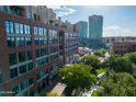 Beautiful brick building with numerous windows and lush trees around it with a view of nearby city buildings at 21 E 6Th St # 412, Tempe, AZ 85281