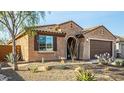 A charming home showcasing desert landscaping, shuttered windows, and a two-car garage at 21362 N 260Th Ln, Buckeye, AZ 85396