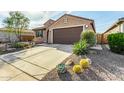 Inviting home with desert landscaping, a two car garage and a well-manicured front yard at 21362 N 260Th Ln, Buckeye, AZ 85396