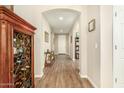 Spacious hallway with wood floors, arched doorways, and decorative accents for an elegant welcome at 21362 N 260Th Ln, Buckeye, AZ 85396