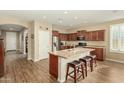 Open kitchen featuring a center island with bar seating and modern stainless steel appliances at 21362 N 260Th Ln, Buckeye, AZ 85396