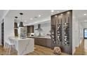 Modern kitchen features a breakfast bar, stylish pendant lighting, and a wine rack wall at 2336 N 12Th St, Phoenix, AZ 85006