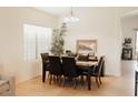 Bright dining room featuring a wood table, seating for six, and natural light from the window at 2509 E Paraiso Dr, Phoenix, AZ 85024