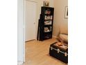 Cozy living area with tan sofa, trunk table, and a bookcase filled with personal items at 2509 E Paraiso Dr, Phoenix, AZ 85024