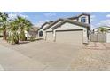 Attractive exterior view of a single-story home, three-car garage, and desert landscaping at 2592 E Torrey Pines Ln, Chandler, AZ 85249