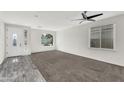 Bright and airy living room with neutral walls, carpet, and a ceiling fan at 2592 E Torrey Pines Ln, Chandler, AZ 85249