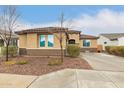 Cozy single-story home featuring a tiled roof and well-landscaped front yard at 25955 W Deer Valley Rd, Buckeye, AZ 85396