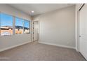 A bright bedroom with a large window allows for ample natural light at 26817 W Renee Dr, Buckeye, AZ 85396