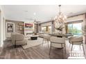 Spacious living room with a fireplace, chandelier, and sliding doors to enhance indoor-outdoor living and entertaining at 30804 N 120Th Ave, Peoria, AZ 85383