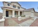 Inviting entryway featuring a covered porch with pillars, a desert landscape and a tile roof at 3115 W Molly Ln, Phoenix, AZ 85083