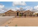 Exterior showcasing desert landscaping, three-car garage, and a charming, well-maintained facade at 35207 N Central Ave, Phoenix, AZ 85086