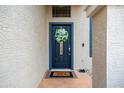 Inviting front door with a decorative wreath and a 'Hello' welcome mat at 3581 W Mineral Butte Dr, San Tan Valley, AZ 85144