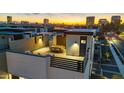 Aerial view of a modern residence featuring a rooftop patio and city skyline at sunset at 377 E Windsor Ave # 19, Phoenix, AZ 85004