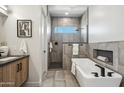 Modern bathroom with a soaking tub, walk-in shower, stylish tile work, and contemporary fixtures at 377 E Windsor Ave # 19, Phoenix, AZ 85004