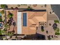 Aerial view of a home featuring solar panels on the roof and a well-manicured yard at 4068 N 155Th Ln, Goodyear, AZ 85395