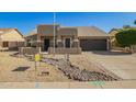 Charming home featuring desert landscaping, neutral colors, and an inviting entry way at 4865 E Princess Dr, Mesa, AZ 85205