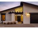 Beautiful home exterior with a unique roofline, xeriscaping, and warm lighting, enhancing its curb appeal at 5449 E Cambridge Ave, Phoenix, AZ 85008