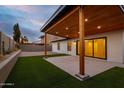 Inviting covered patio features a wood ceiling, decorative pillars, artificial grass, and a concrete surface at 5449 E Cambridge Ave, Phoenix, AZ 85008