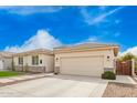 Charming single-story home featuring a well-manicured lawn, desert landscaping and a two car garage at 815 E Tucci St, San Tan Valley, AZ 85140