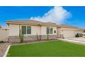 Charming single-story home featuring a well-manicured lawn, desert landscaping and a two car garage at 815 E Tucci St, San Tan Valley, AZ 85140