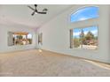 Bright living room featuring a vaulted ceiling, carpet, and several windows providing an abundance of natural light at 9039 W Wescott Dr, Peoria, AZ 85382