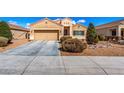 Charming single-story home with a well-manicured front yard, two-car garage, and desert landscaping at 9450 W Georgia Ave, Glendale, AZ 85305