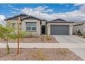 Inviting one-story home with desert landscaping and gray accents, creating a modern aesthetic at 9749 E Ripple Dr, Mesa, AZ 85212