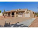 Single-story home with a large driveway and additional covered parking at 1022 W Watson Dr, Tempe, AZ 85283