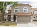 Charming two-story home featuring a well-manicured lawn, neutral colored exterior, and a two car garage at 1249 W Seascape Dr, Gilbert, AZ 85233